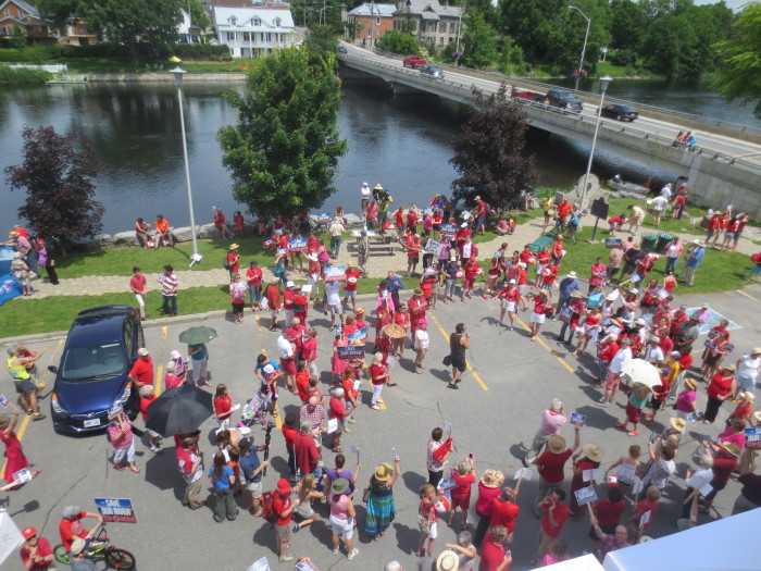 Many residents arrived well before the scheduled noon gathering time wearing red shirts, hats, and other apparel.