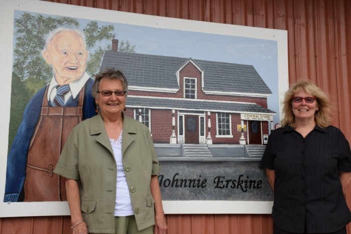 Mary Lou Labrie, left, and Laurel Cook at the Erskine mural, outside the Clayton General Store’s shed on Tatlock Road. Photo: © Fay Devlin