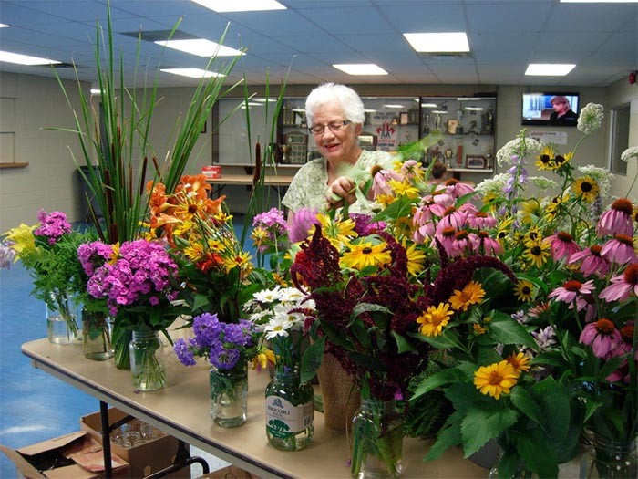 Marilyn Snedden works on creating centerpieces for the tables / July 24, 2015